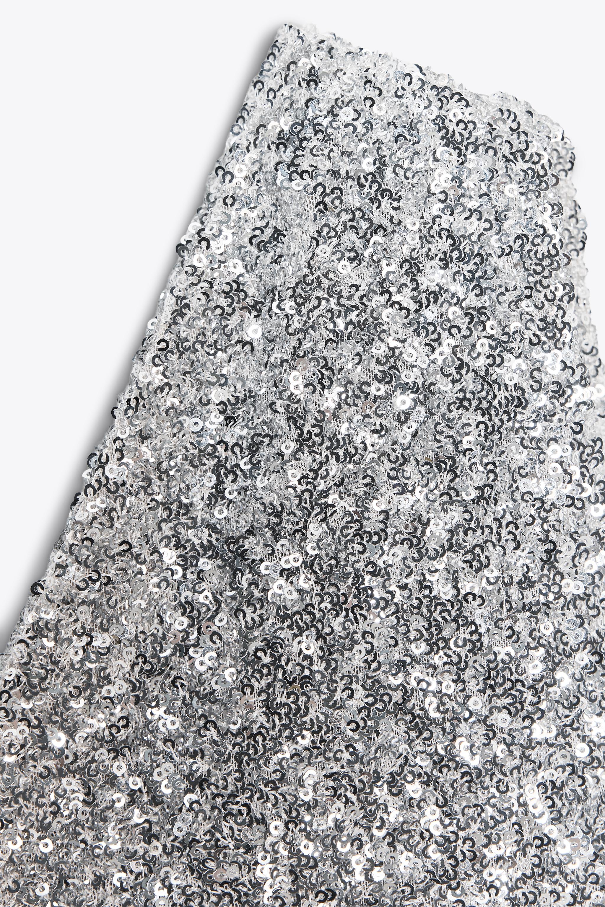 TOP ASYMÉTRIQUE À PAILLETTES